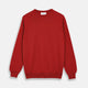 The Turnbull & Asser Red Cashmere Crewneck Jumper features long sleeves, ribbed cuffs and hem, showcasing classic Scottish knitwear elegance. Displayed on a white background.