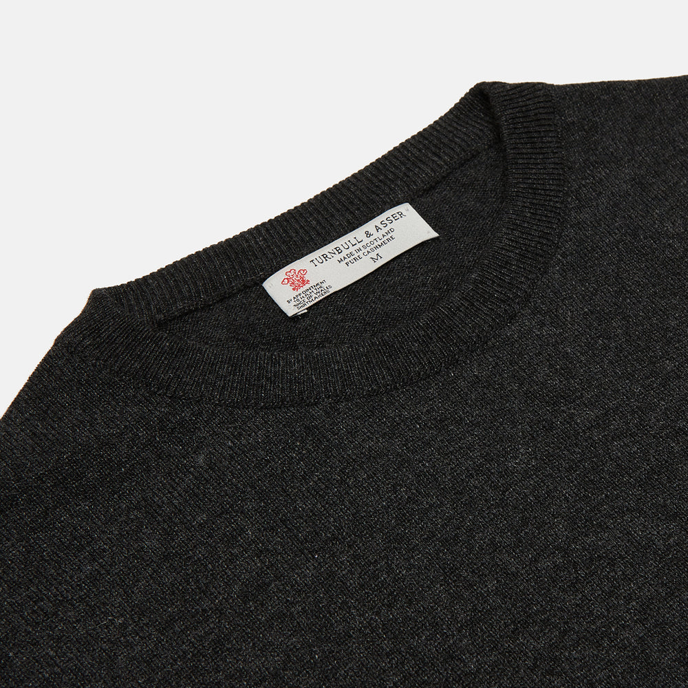 The Charcoal Crew Neck Cashmere Jumper by Turnbull & Asser is a luxury, long-sleeved sweater crafted from Scottish cashmere and shown on a white background.