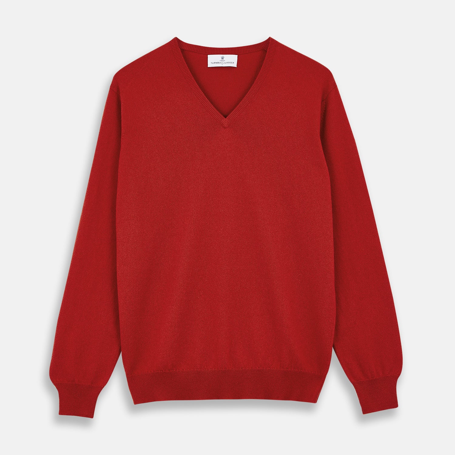 View 1 of product The Turnbull & Asser Red Cashmere V-Neck Jumper features long sleeves and ribbed cuffs and hem, shown laid flat on a white background.