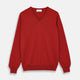 The Turnbull & Asser Red Cashmere V-Neck Jumper features long sleeves and ribbed cuffs and hem, shown laid flat on a white background.