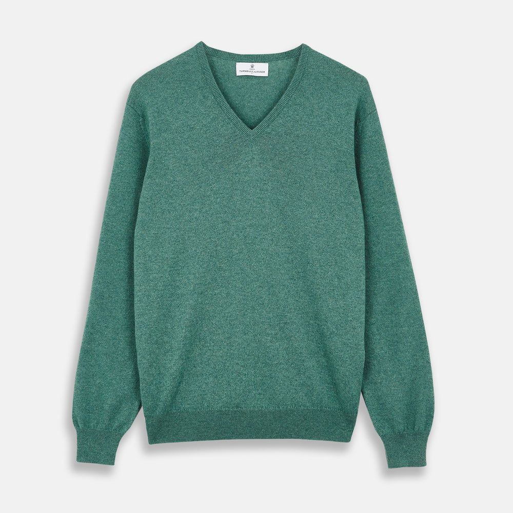 The Turnbull & Asser Green Cashmere V-Neck Jumper features long sleeves, ribbed cuffs and hem, and is styled in classic Scottish knitwear, shown flat against a white background.