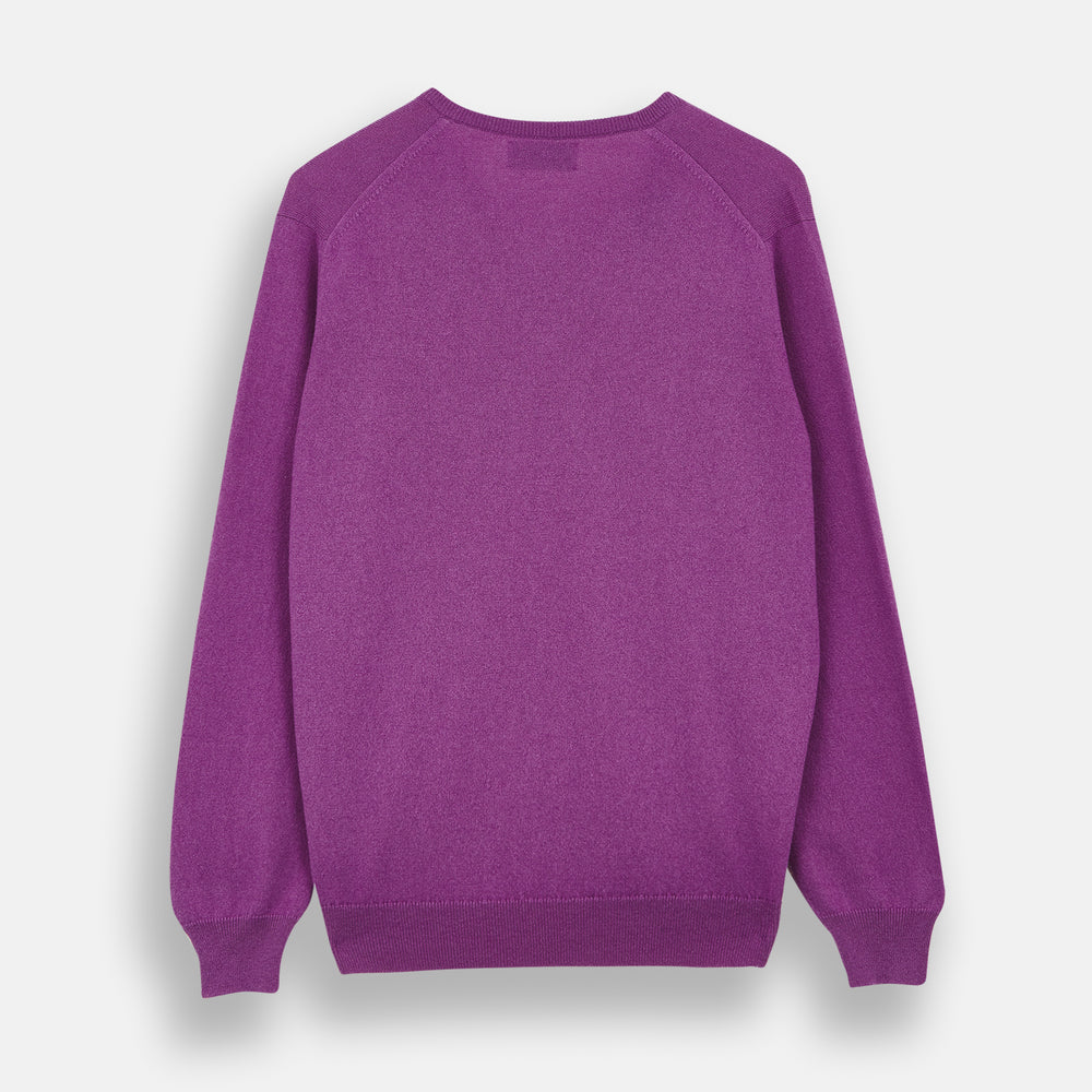 The Turnbull & Asser Magenta Cashmere V-Neck Jumper features long sleeves, ribbed cuffs, and a ribbed hem, shown against a plain white background.