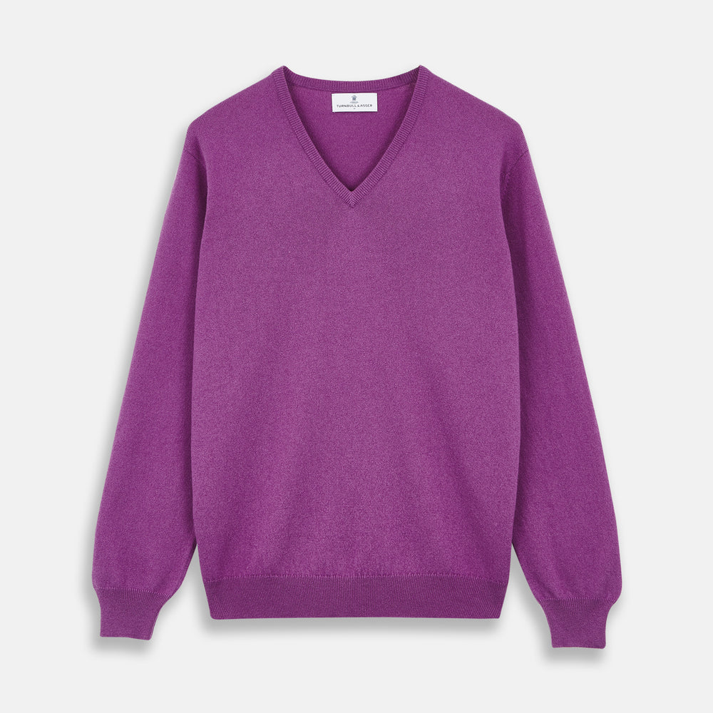 The Turnbull & Asser Magenta Cashmere V-Neck Jumper features long sleeves, ribbed cuffs, and a ribbed hem, shown against a plain white background.
