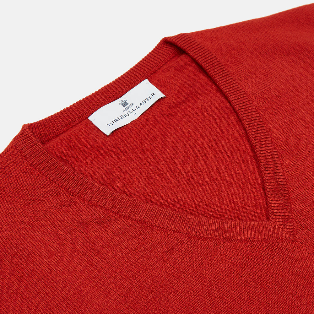 The Red Cashmere Slipover by Turnbull & Asser is a sleeveless, V-neck vest in pure cashmere, shown flat on a white background—an ideal lightweight layer for any season.