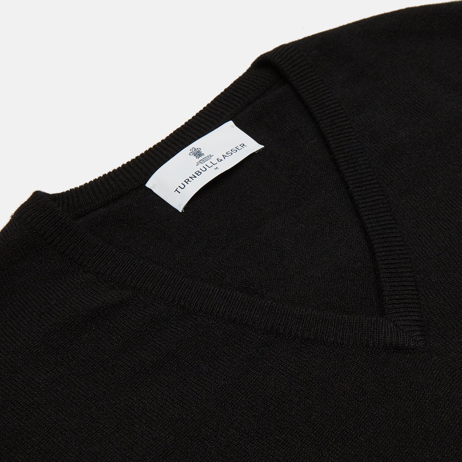 View 2 of product The Turnbull & Asser Black Cashmere Slipover, a sleeveless V-neck sweater vest made from pure cashmere, is shown flat against a white background.