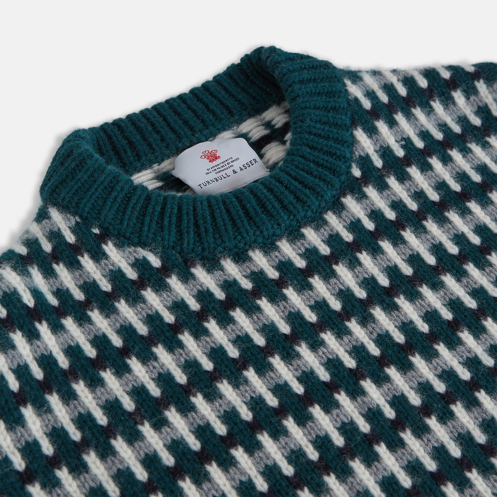 The Holly Green Knitted Cashmere Crewneck Jumper by Turnbull & Asser features a ribbed neckline, cuffs, and hem—a timeless investment piece for fans of signature knits.