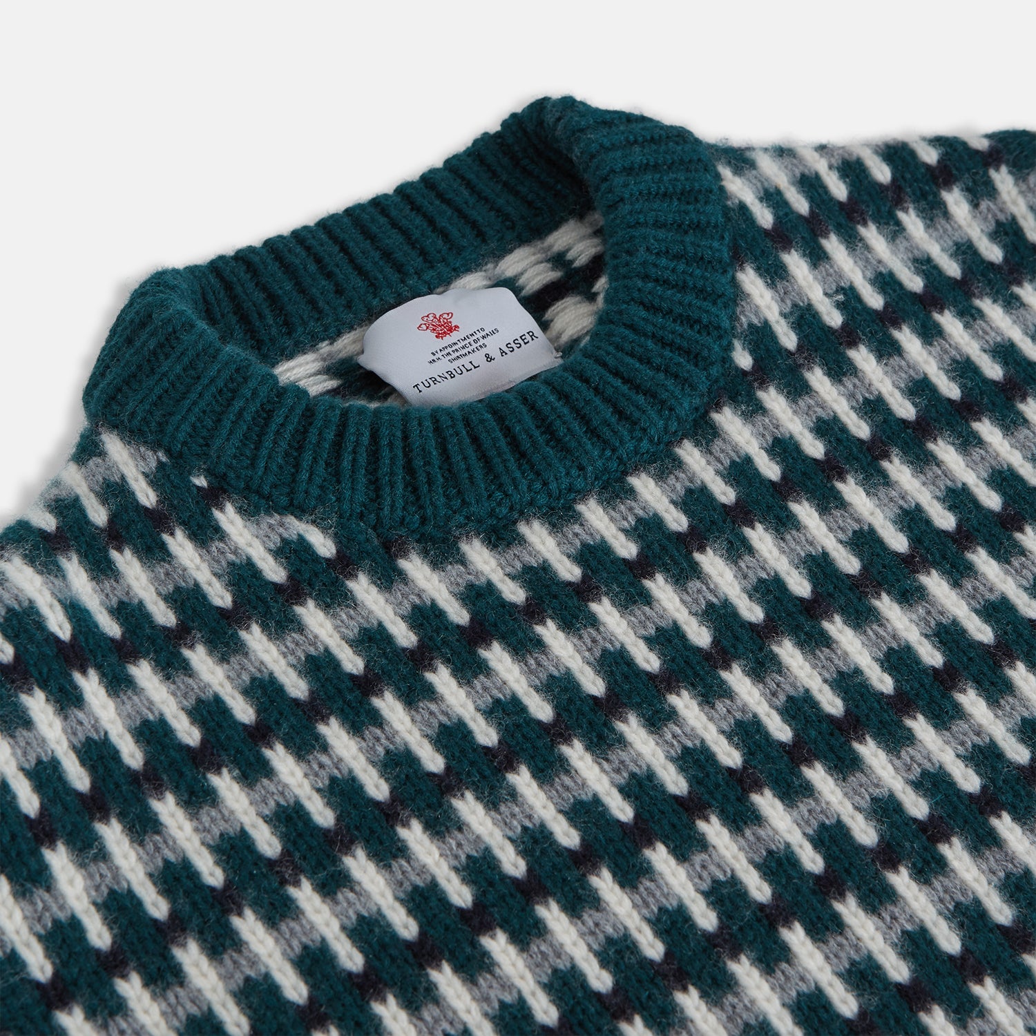 View 4 of product The Holly Green Knitted Cashmere Crewneck Jumper by Turnbull & Asser features a ribbed neckline, cuffs, and hem—a timeless investment piece for fans of signature knits.