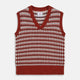 The Rust Knitted Cashmere Slipover by Turnbull & Asser is a sleeveless V-neck vest in red, white, and dark brown houndstooth, inspired by Welsh knitwear with solid red ribbed trim at the collar, armholes, and hem.