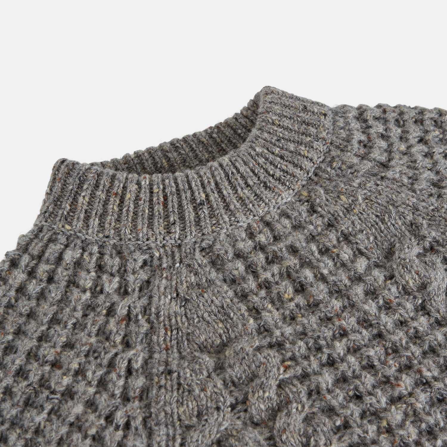 View 4 of product The Turnbull & Asser Merino Knitted Raglan Sleeve Crewneck Jumper in gray features intricate front and sleeve knit patterns, a high neckline, and long sleeves—an essential piece of men’s knitwear. Laid flat on a white background.