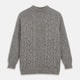 The Turnbull & Asser Merino Knitted Raglan Sleeve Crewneck Jumper in gray features intricate front and sleeve knit patterns, a high neckline, and long sleeves—an essential piece of men’s knitwear. Laid flat on a white background.