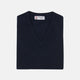 A neatly folded Turnbull & Asser Navy V-Neck Cashmere Slipover is displayed on a plain white background, its inner neckline label visible.