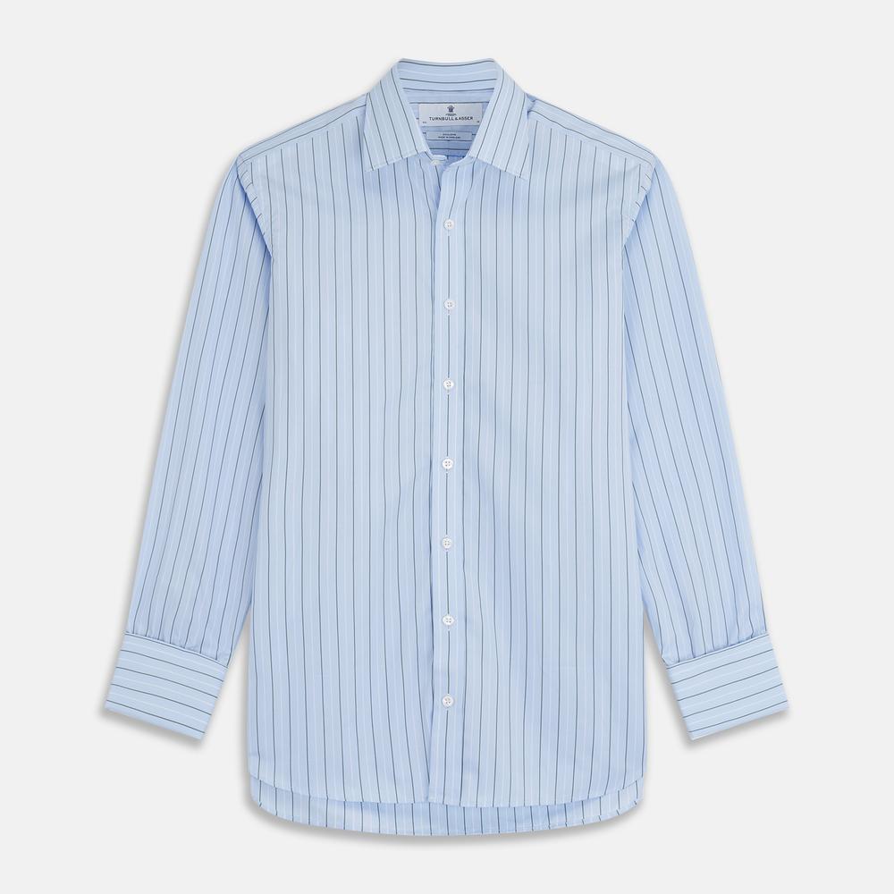 A close-up of Turnbull & Asser’s Green Stripe Cotton Fabric shows light blue material with evenly spaced white and dark gray vertical stripes, presented in a circular frame against a plain background.