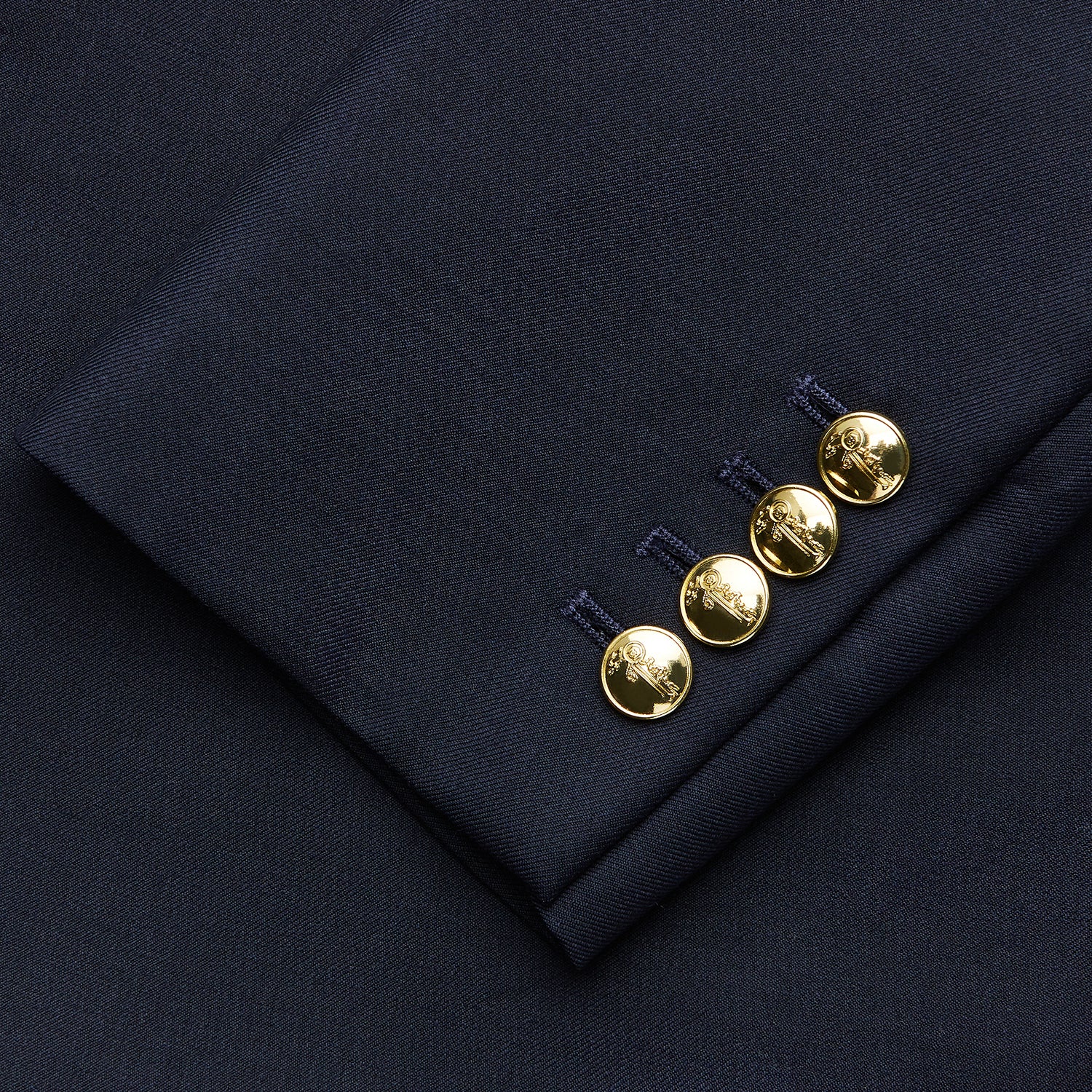 View 3 of product The Turnbull & Asser Navy Plain Wool Single Breasted Blazer features brass buttons on the front and cuffs, notched lapels, and multiple front pockets, shown laid flat against a white background.