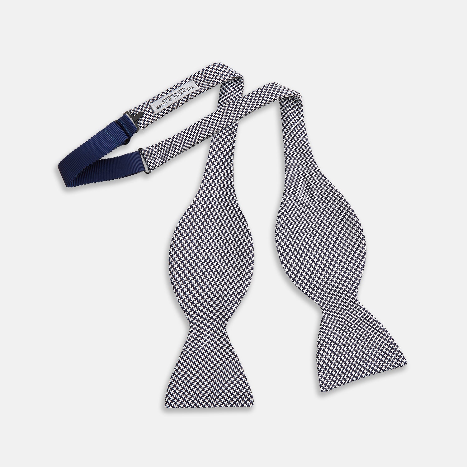 View 2 of product The Turnbull & Asser Black Houndstooth Silk Bow Tie features a classic black and white pattern, displayed against a plain white background—an elegant choice to elevate any formal ensemble.
