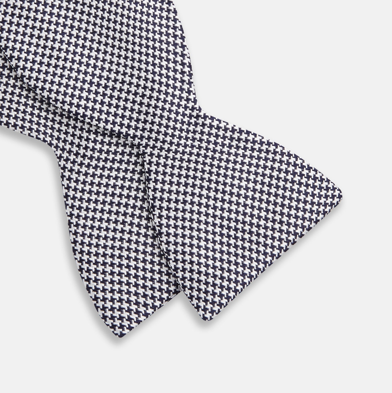 View 3 of product The Turnbull & Asser Black Houndstooth Silk Bow Tie features a classic black and white pattern, displayed against a plain white background—an elegant choice to elevate any formal ensemble.