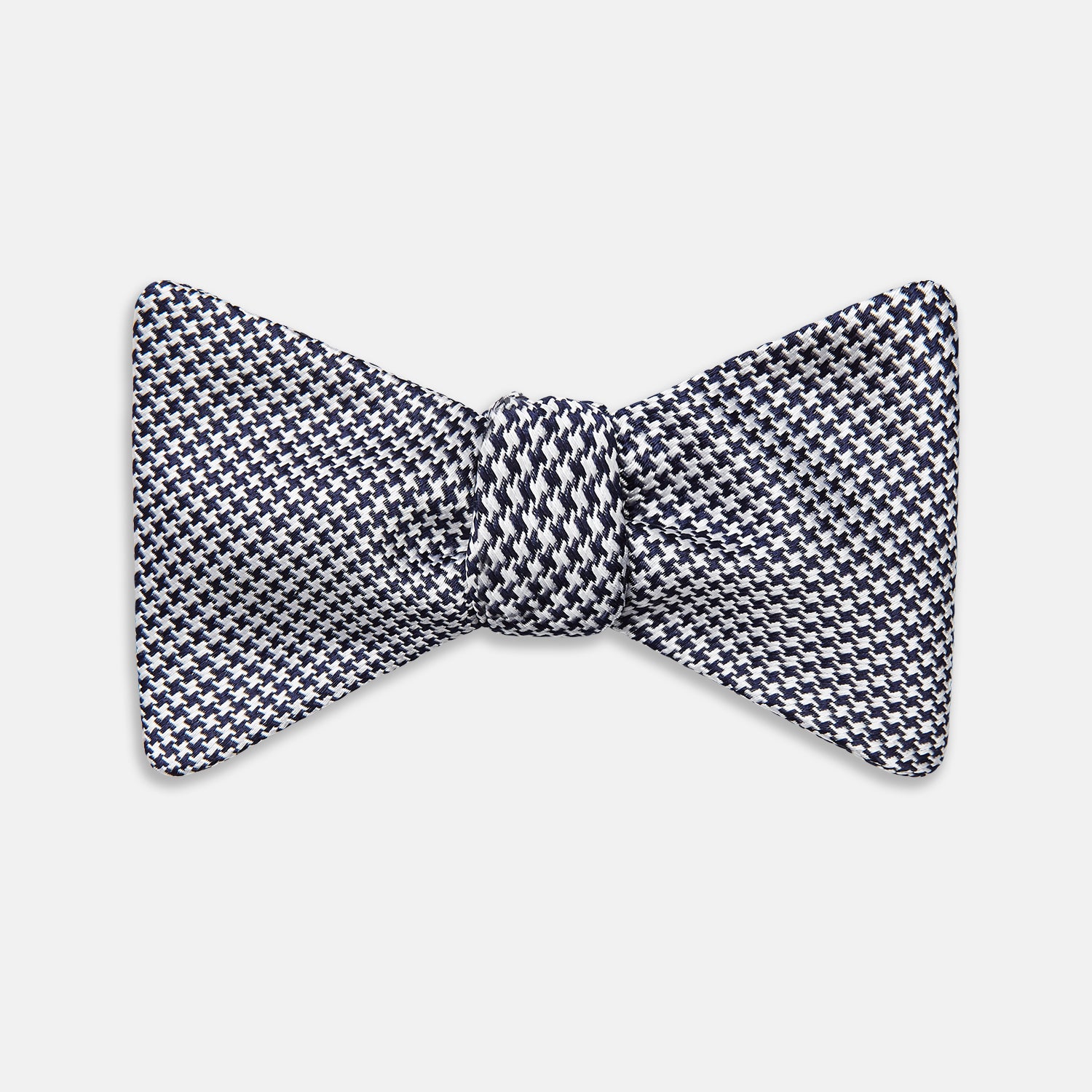 View 1 of product The Turnbull & Asser Black Houndstooth Silk Bow Tie features a classic black and white pattern, displayed against a plain white background—an elegant choice to elevate any formal ensemble.