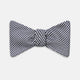 The Turnbull & Asser Black Houndstooth Silk Bow Tie features a classic black and white pattern, displayed against a plain white background—an elegant choice to elevate any formal ensemble.