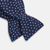 View 3 of product The Turnbull & Asser Navy and Blue Paint Spot Silk Bow Tie features a refined pattern of blue dots on navy, making it an essential addition to any men's accessories collection. Photographed on a plain white background.