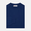 View 1 of product The Turnbull & Asser Blue Crew Neck Cashmere Jumper, neatly folded with ribbed collar and cuffs, is shown on a plain white background. A small label appears inside the collar.