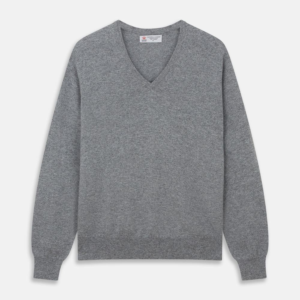 The Turnbull & Asser Flannel Grey V-Neck Cashmere Jumper, shown laid flat on a white background, features long sleeves and ribbed cuffs, hem, and neckline for a classic look with no visible patterns or embellishments.