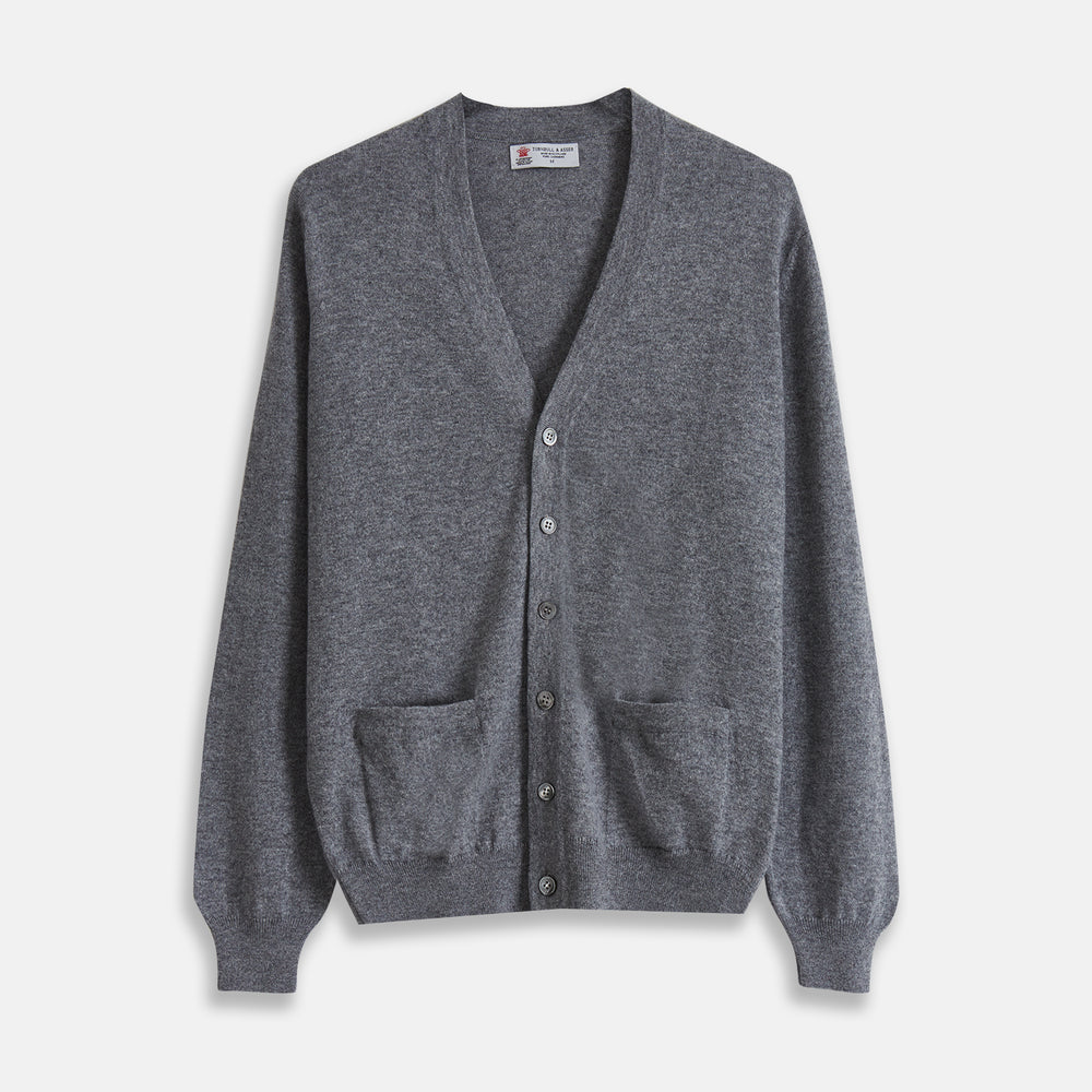 The Grey Fine Cashmere Cardigan by Turnbull & Asser is a long-sleeve, button-up sweater with two front pockets, shown on a white background.