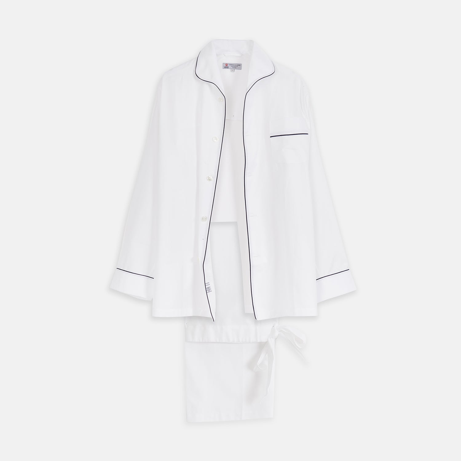 View 1 of product The Turnbull & Asser White Herringbone Piped Superfine Cotton Pyjama Set features a long-sleeve button-up top and drawstring pants with black piping, all crafted from superfine cotton and shown against a plain white background.