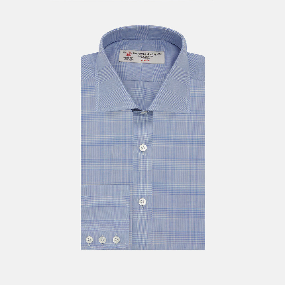 A Turnbull & Asser Blue Prince of Wales Check Shirt with Regent collar and button cuffs, neatly folded to show its white buttons and inside-collar label, is displayed against a plain white background.