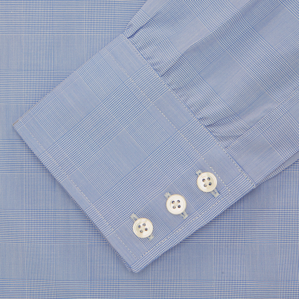 A Turnbull & Asser Blue Prince of Wales Check Shirt with Regent collar and button cuffs, neatly folded to show its white buttons and inside-collar label, is displayed against a plain white background.