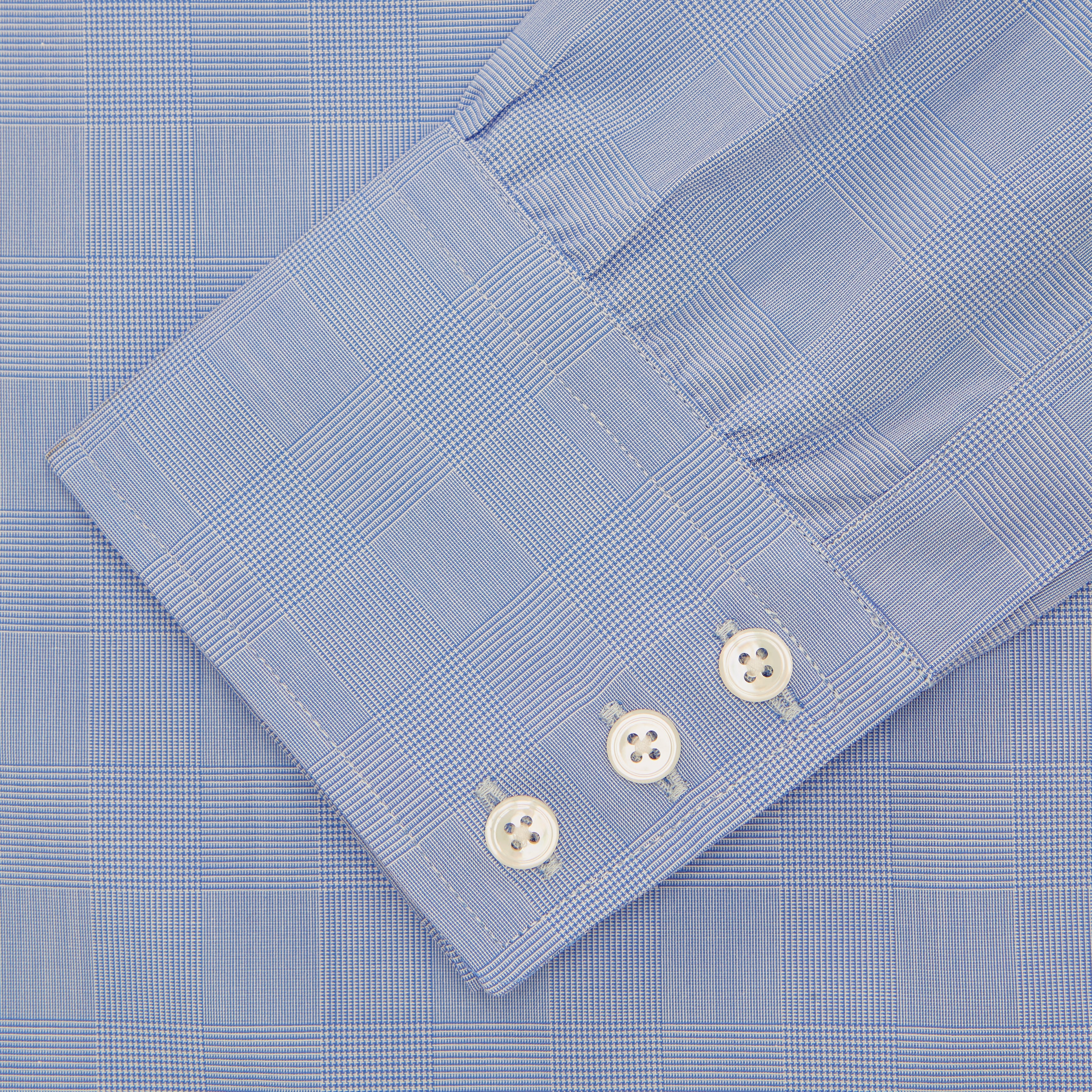 View 2 of product A Turnbull & Asser Blue Prince of Wales Check Shirt with Regent collar and button cuffs, neatly folded to show its white buttons and inside-collar label, is displayed against a plain white background.