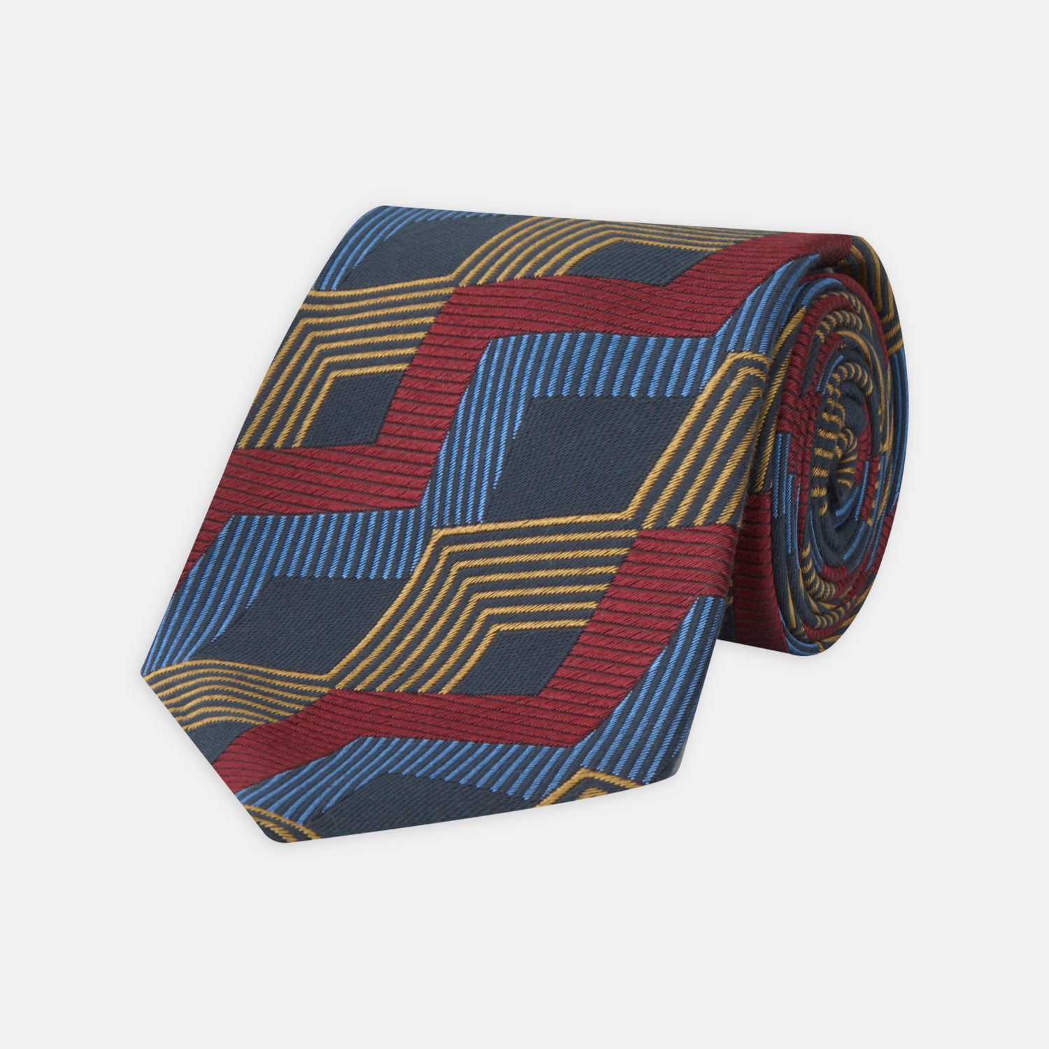 View 1 of product The Navy, Red and Gold Zig Zag Silk Tie by Turnbull & Asser features a geometric pattern of zigzag stripes on a dark background and is part of our limited-run collection.