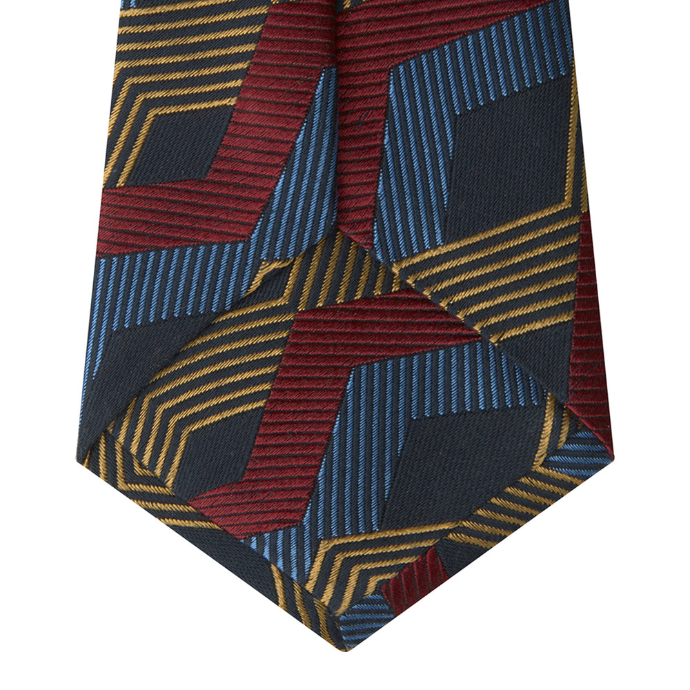 The Navy, Red and Gold Zig Zag Silk Tie by Turnbull & Asser features a geometric pattern of zigzag stripes on a dark background and is part of our limited-run collection.