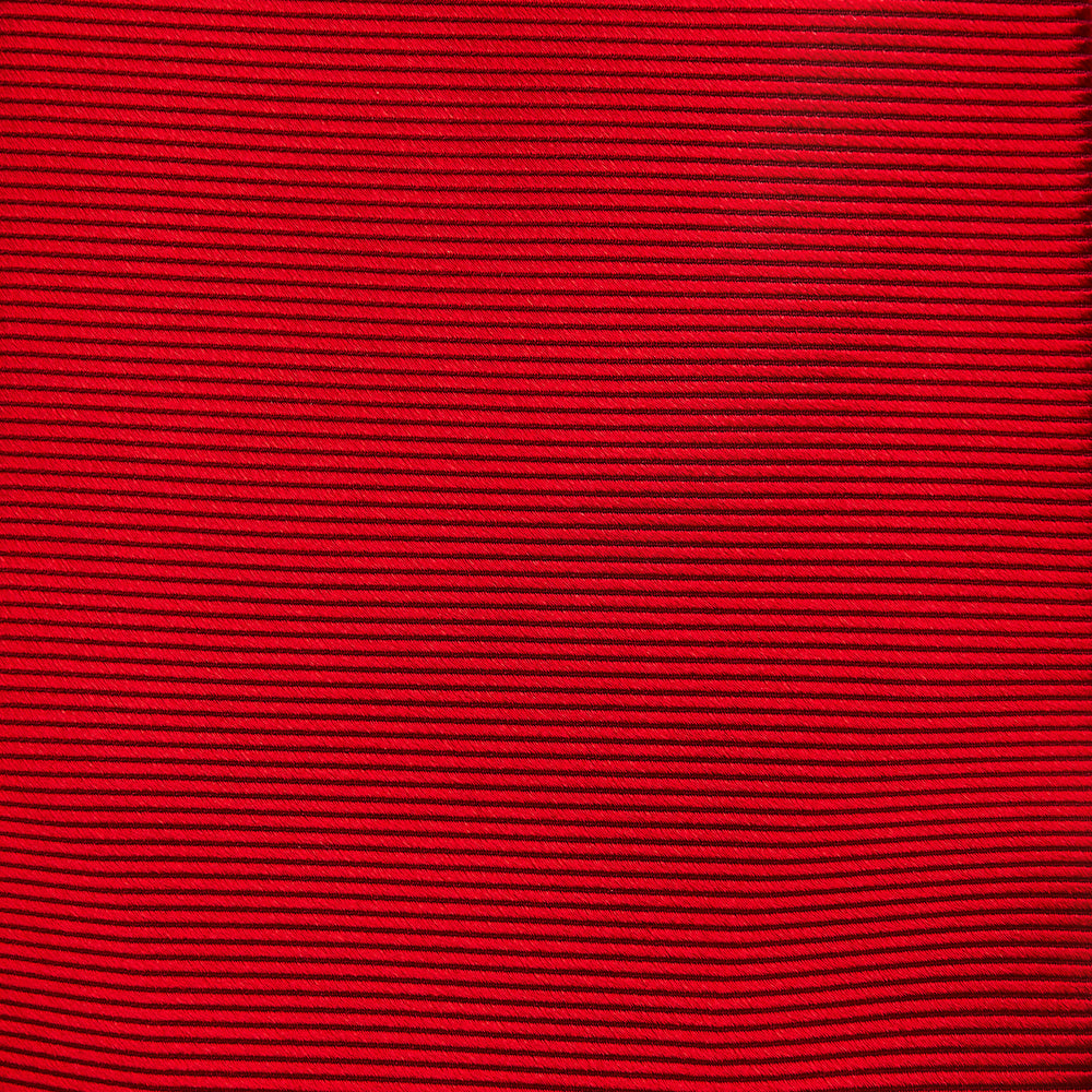 The Turnbull & Asser Red Horizontal Twill Silk Tie, rolled up, is ideal for adding a smart touch to cotton shirts.