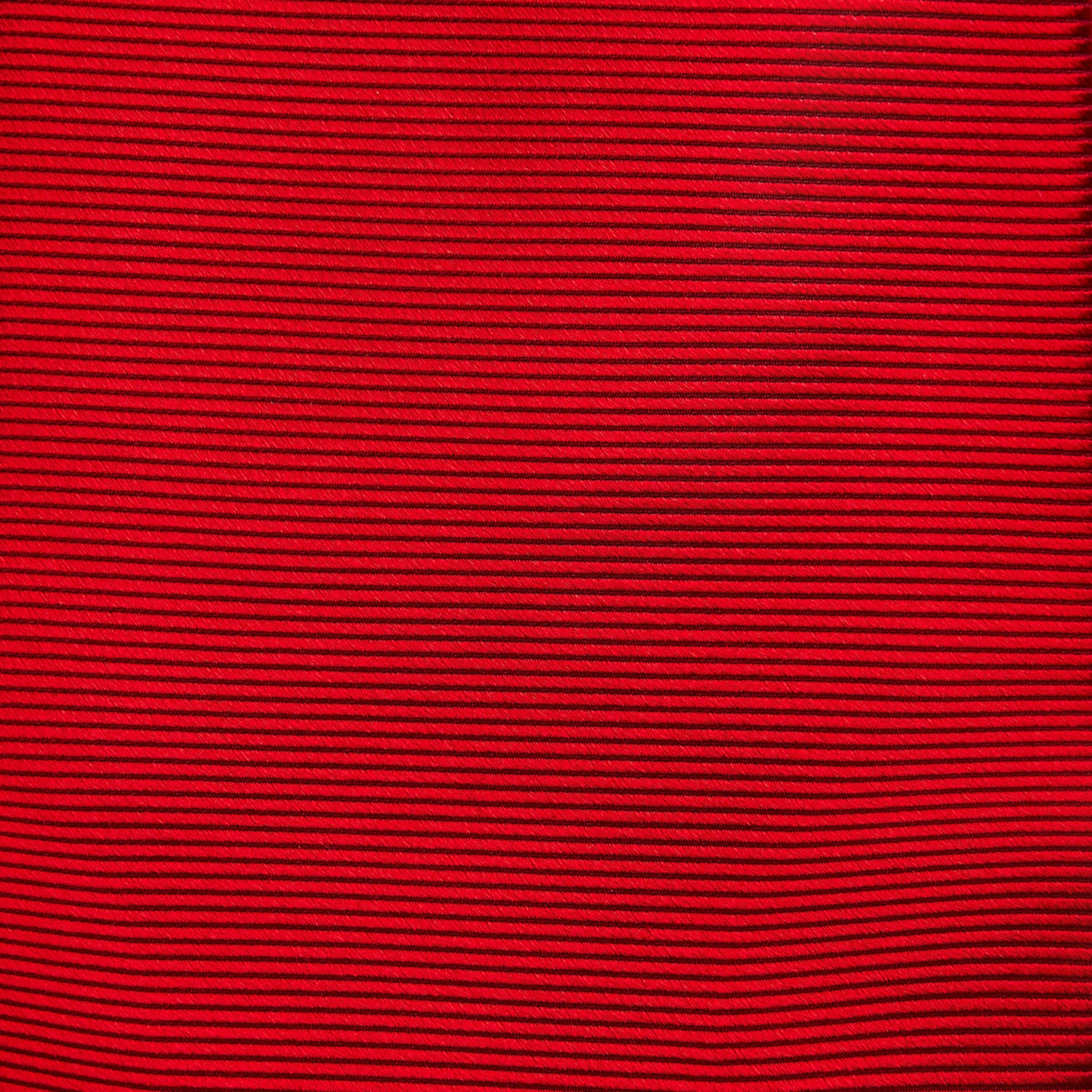 View 3 of product The Turnbull & Asser Red Horizontal Twill Silk Tie, rolled up, is ideal for adding a smart touch to cotton shirts.