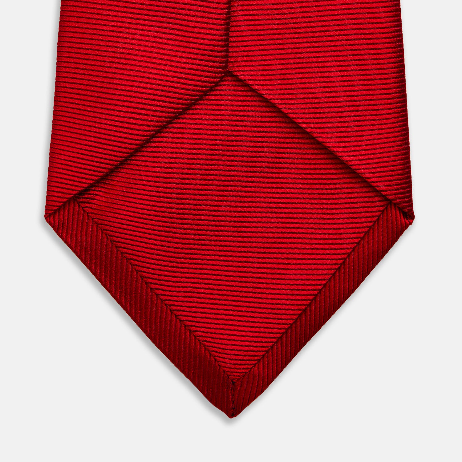 View 4 of product The Turnbull & Asser Red Horizontal Twill Silk Tie, rolled up, is ideal for adding a smart touch to cotton shirts.