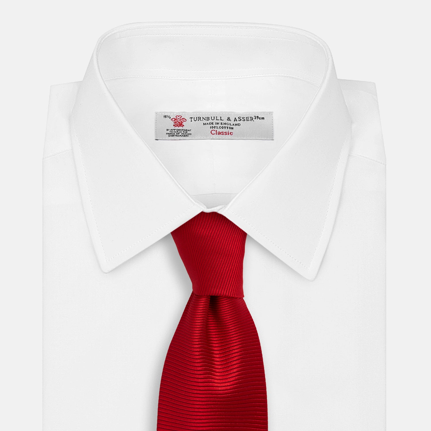 View 2 of product The Turnbull & Asser Red Horizontal Twill Silk Tie, rolled up, is ideal for adding a smart touch to cotton shirts.