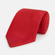 The Turnbull & Asser Red Horizontal Twill Silk Tie, rolled up, is ideal for adding a smart touch to cotton shirts.
