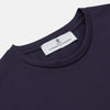 View 2 of product The Turnbull & Asser Navy Davey Cotton T-Shirt, made from fine-gauge jersey fabric, features short sleeves, a crew neck, and a small white tag with text inside the back collar, displayed flat on a white background.