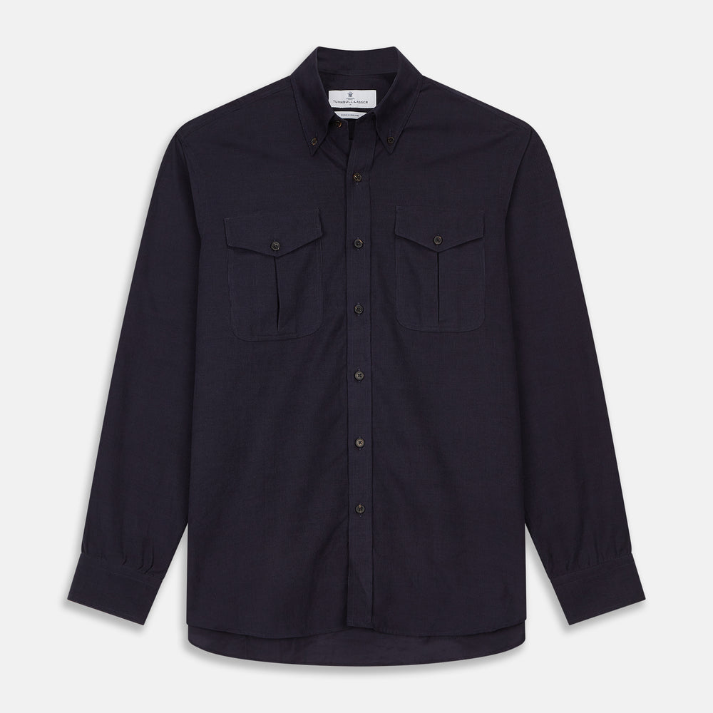 The Turnbull & Asser Midnight Blue Corduroy Officer Weekend Fit Shirt features a soft Dorset collar, relaxed fit, 1-button cuffs, and two button-flap chest pockets, shown on a white background.