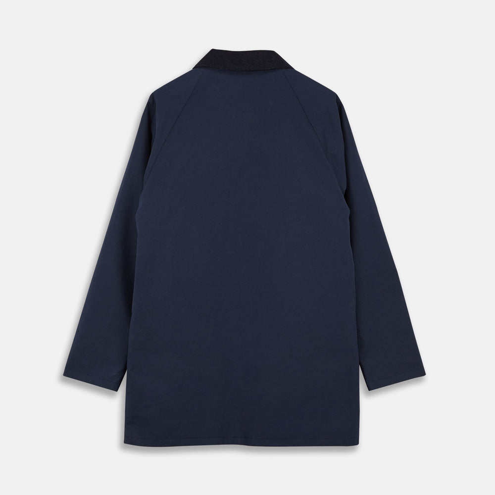 The Turnbull & Asser Navy Dry-Waxed Cotton Field Jacket features a collar, front zipper with snap buttons, two chest pockets, and large hip flap pockets, shown laid flat on a plain white background.