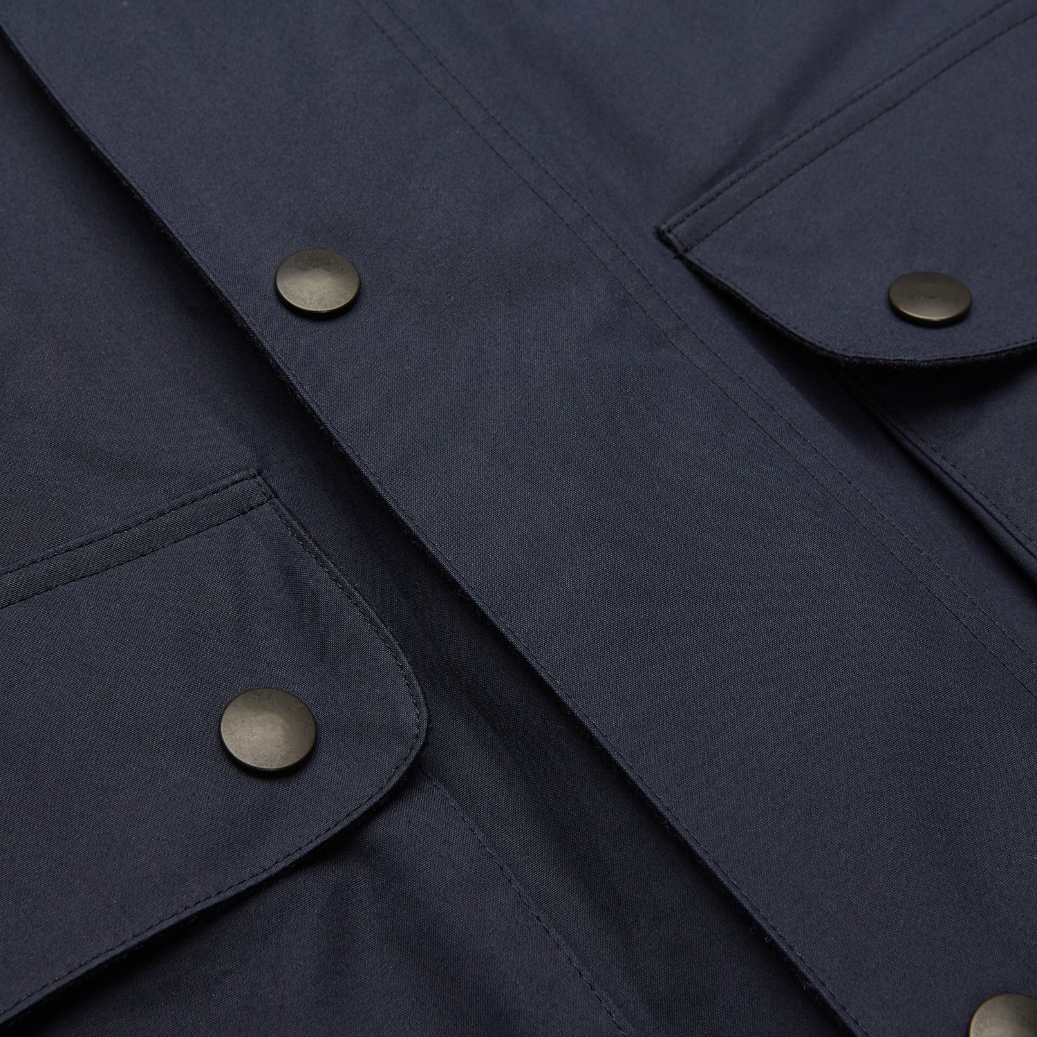 View 6 of product The Turnbull & Asser Navy Dry-Waxed Cotton Field Jacket features a collar, front zipper with snap buttons, two chest pockets, and large hip flap pockets, shown laid flat on a plain white background.