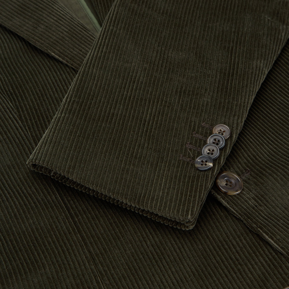 The Turnbull & Asser Olive Green Corduroy Jacket, crafted from pure cotton with notched lapels, two buttons, patch and welt chest pockets, displays Italian tailoring and is shown laid flat on a white background.