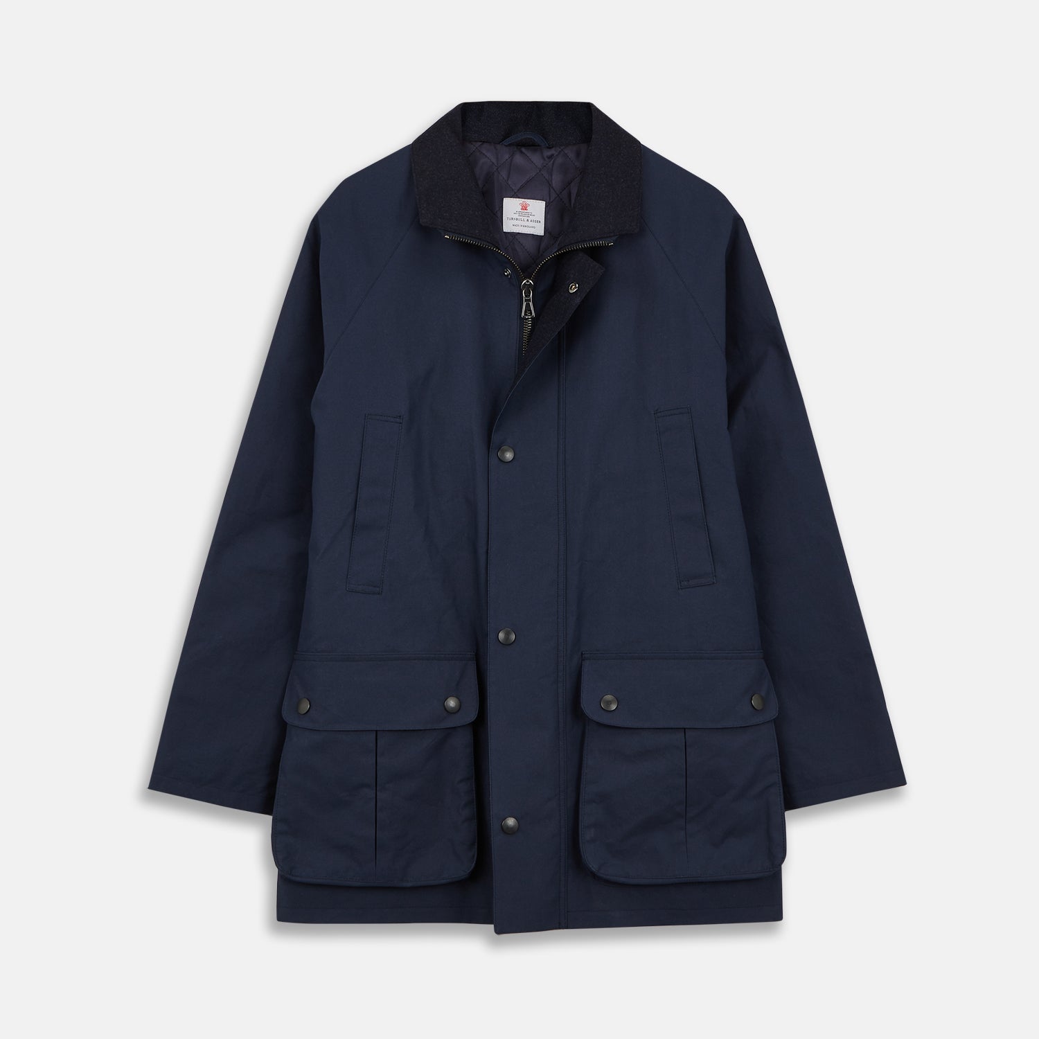 View 1 of product The Turnbull & Asser Navy Dry-Waxed Cotton Field Jacket features a collar, front zipper with snap buttons, two chest pockets, and large hip flap pockets, shown laid flat on a plain white background.