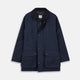 The Turnbull & Asser Navy Dry-Waxed Cotton Field Jacket features a collar, front zipper with snap buttons, two chest pockets, and large hip flap pockets, shown laid flat on a plain white background.
