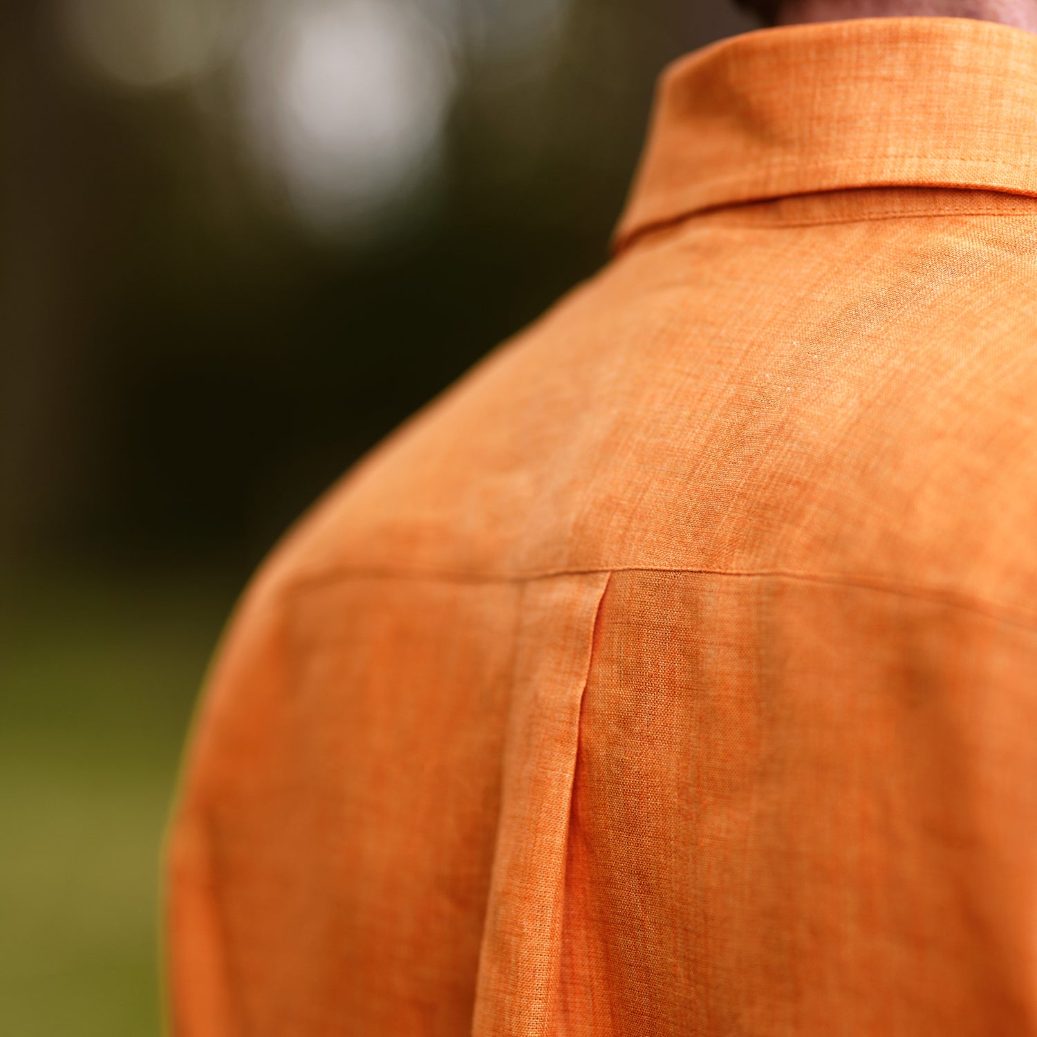 View 3 of product The Turnbull & Asser Orange Weekend Fit Linen Nevis Shirt features a Derby collar, long sleeves with 1-button cuffs, white buttons, and a chest pocket, shown flat against a white background.