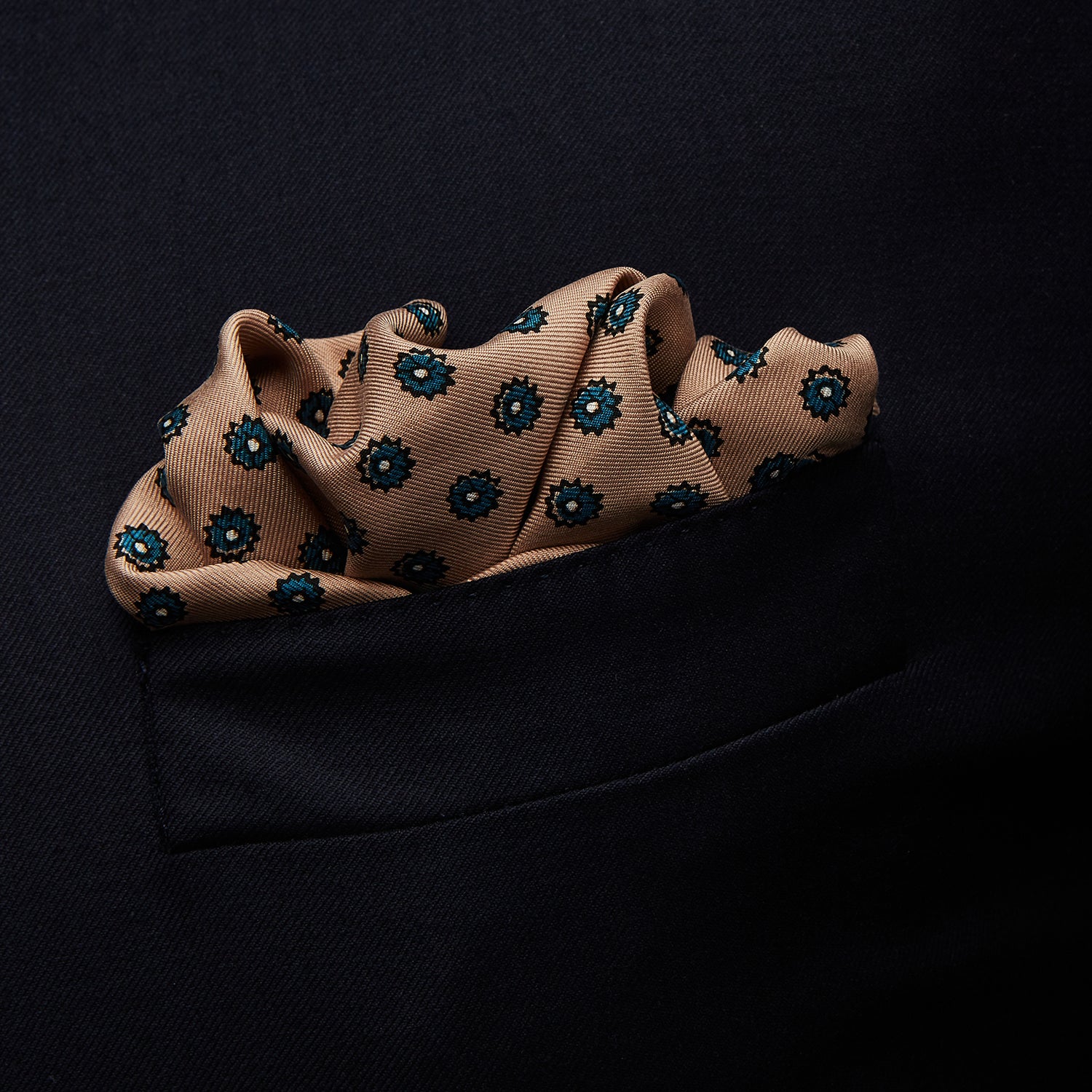 View 3 of product The Copper Fine Floral Print Silk Pocket Square by Turnbull & Asser features a refined floral pattern in silk, with the brand’s name discreetly displayed in one corner—a perfect choice for those who appreciate elegant pocket squares.