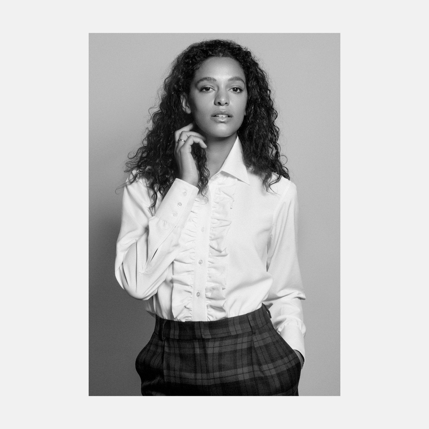 View 2 of product The Turnbull & Asser Turnbull and The Deck Cream Silk Romantic Shirt features long sleeves, a pointed collar, and elegant front ruffles, shown against a plain light gray background.