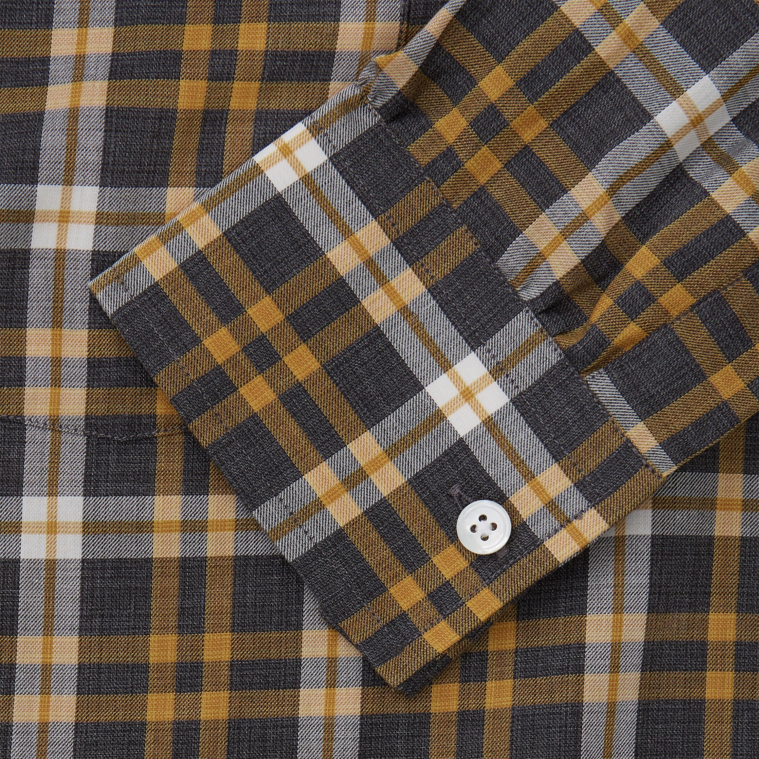 View 3 of product The Turnbull & Asser Yellow Check Weekend Fit Flannel Shirt features a Derby collar, 1-button cuffs, and a yellow, black, and white plaid pattern. It is shown laid flat on a white background.