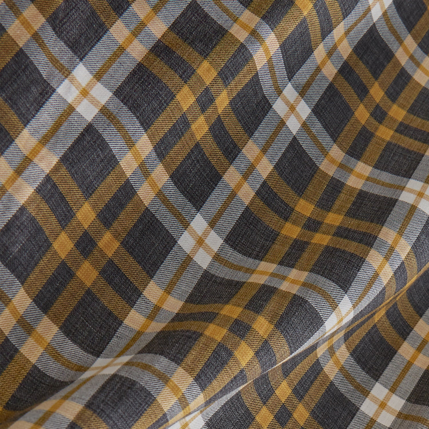 View 4 of product The Turnbull & Asser Yellow Check Weekend Fit Flannel Shirt features a Derby collar, 1-button cuffs, and a yellow, black, and white plaid pattern. It is shown laid flat on a white background.