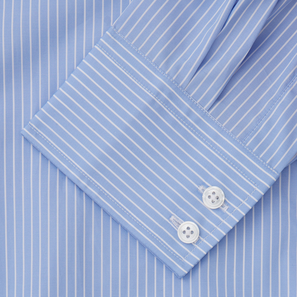 The Turnbull & Asser Powder Blue Stripe Tailored Fit Shirt features a Kent collar and 2-button cuffs, with powder blue and white vertical pinstripes, shown against a plain white background.