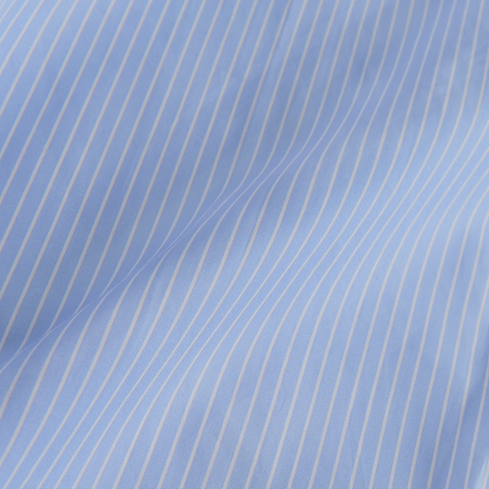 The Turnbull & Asser Powder Blue Stripe Tailored Fit Shirt features a Kent collar and 2-button cuffs, with powder blue and white vertical pinstripes, shown against a plain white background.
